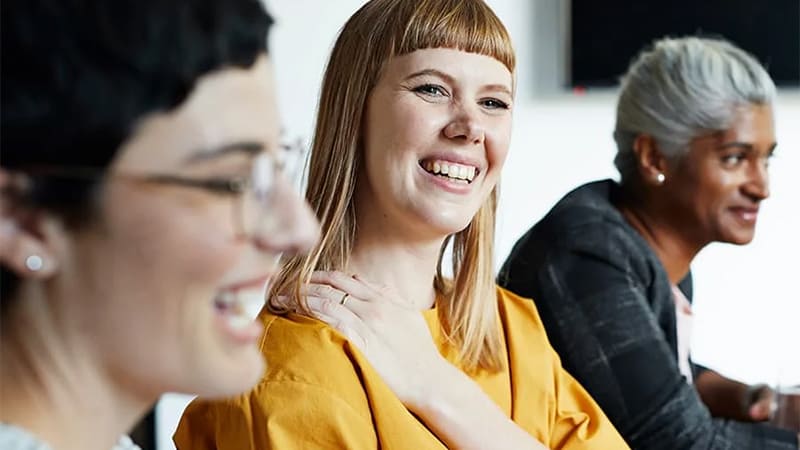 Three people smiling