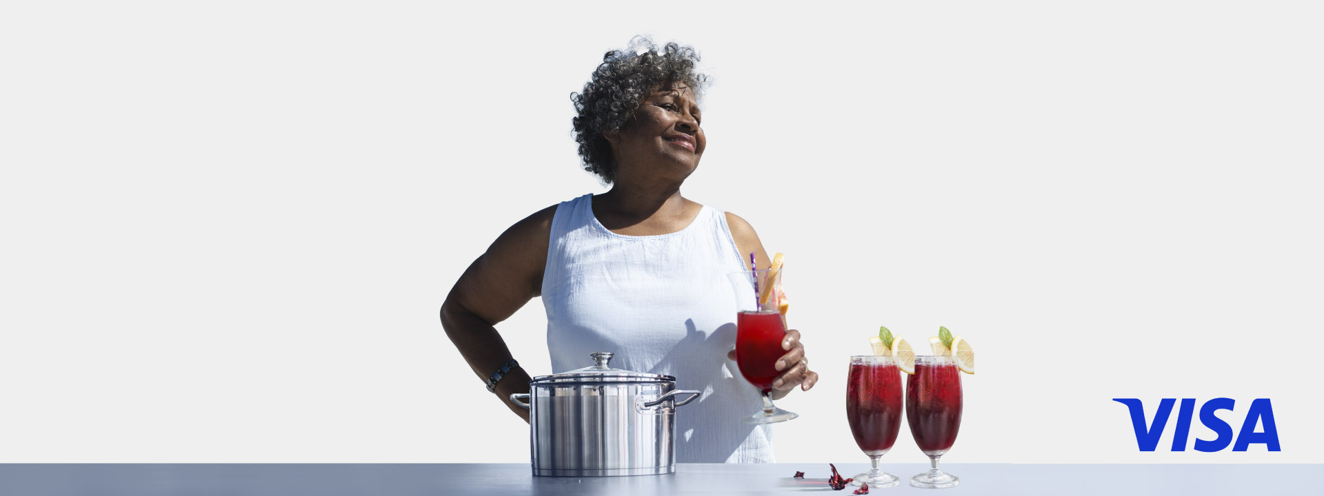A woman holding a drink in her hand